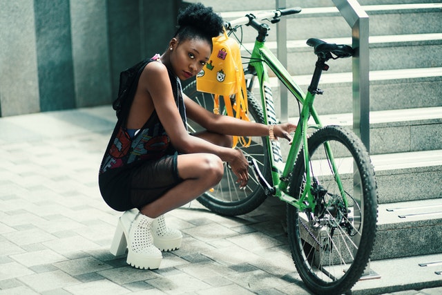 Girl looking bad a** next to bike