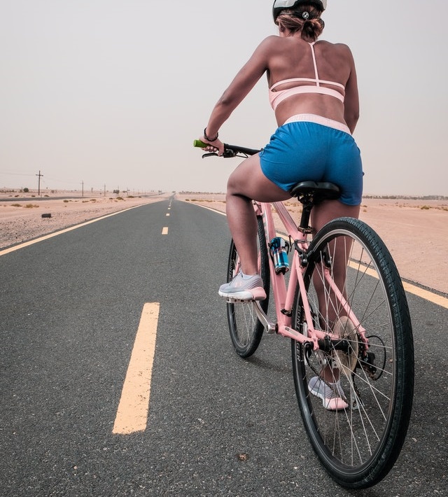 Woman riding bike in desert