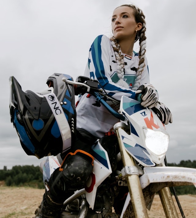 Woman with helmet riding motocross