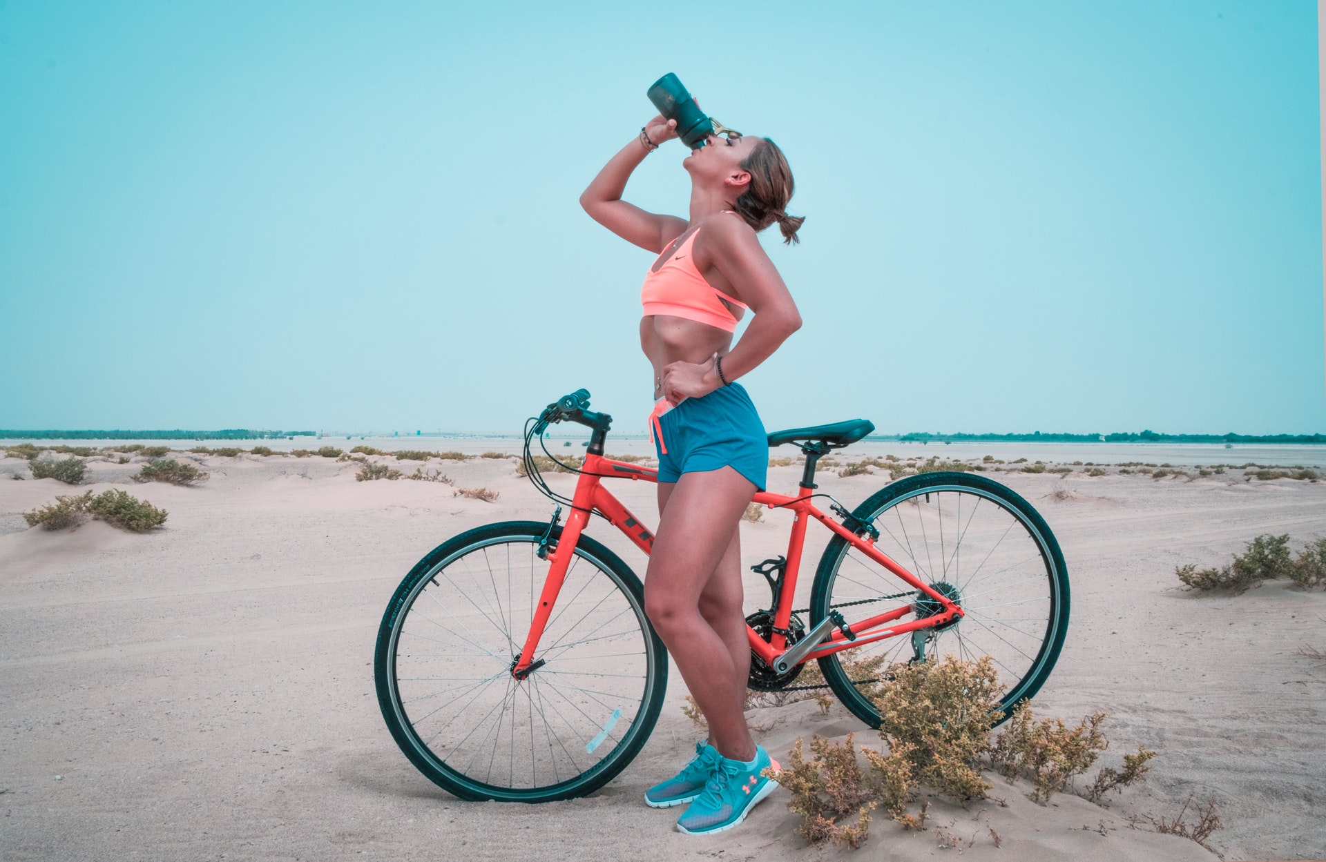 Biker woman drinking water